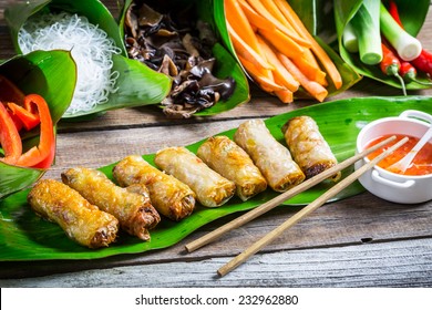 Fried spring rolls surrounded by ingredients