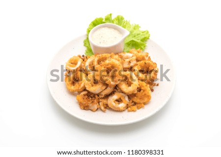 fried squids or octopus (calamari) with sauce isolated on white background