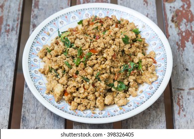 fried stir basil with minced pork put on wooden table