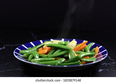 Fried And Stirred Sliced Baby Corn, Carrot And String Bean On The Plate. Famous Traditional Vegetarian Menu In Chinese Restaurant. High Fiber And Low Fat Food. 