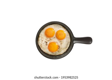 Fried Sunny Side Up Eggs In Black Pan Isolated On White, Top View