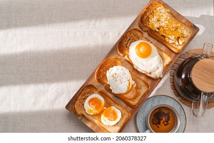 Fried Toast Bread With Four Different Types Of Cooked Chicken Eggs, Scrambled Eggs, Fried Eggs, Poached Egg And Creamed Egg. Breakfast Of Chicken Eggs.