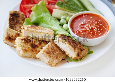 Fried tofu with fresh salad. Vegan food close up. Tofu steaks. Plantbased diet