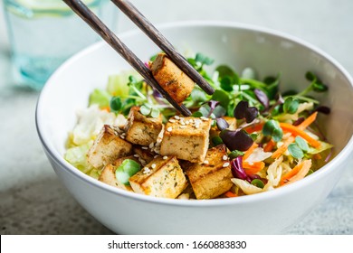 Fried Tofu Salad With Sprouts And Sesame Seeds In A White Bowl. Vegan Food, Asian Food Concept.