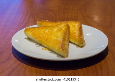 Fried triangle bread with butter.