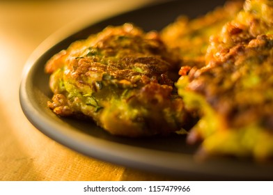 Fried vegetable fritters with zucchini, carrots, herbs, eggs, and cheese. - Shutterstock ID 1157479966