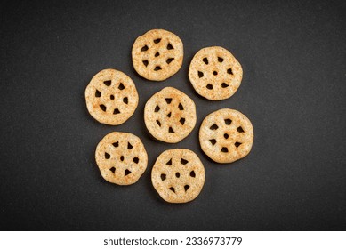 Fried wheel Snacks. Wheel Fryums.
closeup top view in black background. Masala Wheel. Wheels namkeen. Wheel Cracker.