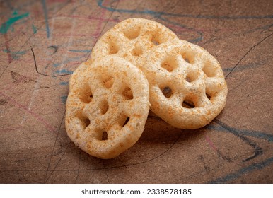 Fried wheel Snacks. Wheel Fryums.
closeup served in wood background. Masala Wheel. Wheels namkeen. Wheel Cracker.