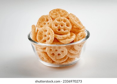 Fried wheel Snacks. Wheel Fryums.
served in round glass bowl isolated on white background. Masala Wheel. Wheels namkeen. Wheel Cracker.