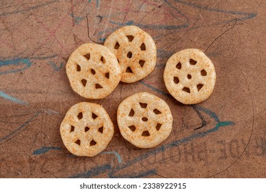Fried wheel Snacks. Wheel Fryums.
Top view closeup served in wood background. Masala Wheel. Wheels namkeen. Wheel Cracker.
