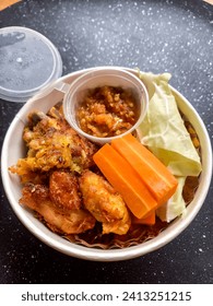 friedchicken in the ricw bowl with carrots and sambal