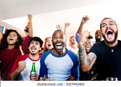 Frieds cheering sport at bar together