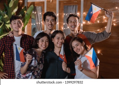 friend celebrating philippines national independence day party at night in the home backyard together - Powered by Shutterstock