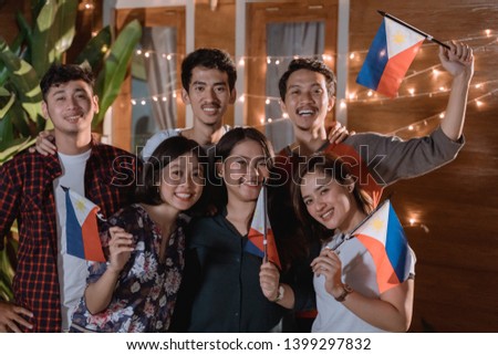 friend celebrating philippines national independence day party at night in the home backyard together