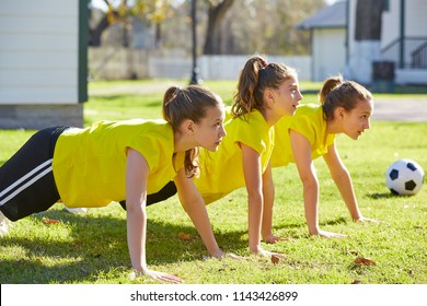 Friend girls teens push up push-ups workout ABS in a park turf grass - Powered by Shutterstock