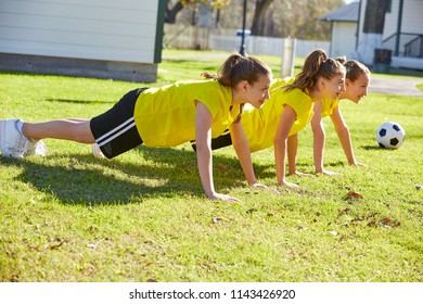 Friend girls teens push up push-ups workout ABS in a park turf grass - Powered by Shutterstock