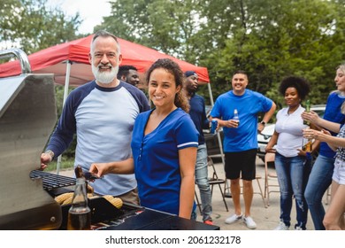 Friend Grilling Burgers At A Tailgate Party