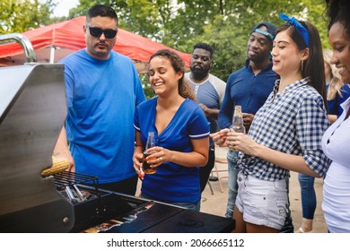 Friend grilling burgers at a tailgate party