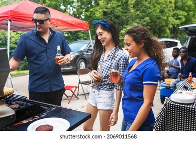 Friend Grilling Burgers At A Tailgate Party