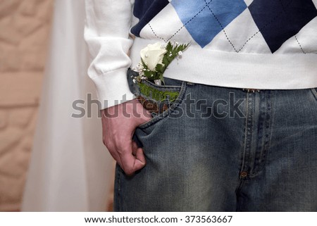 Similar – Man in jeans and plaid shirt with some white flowers in his hand