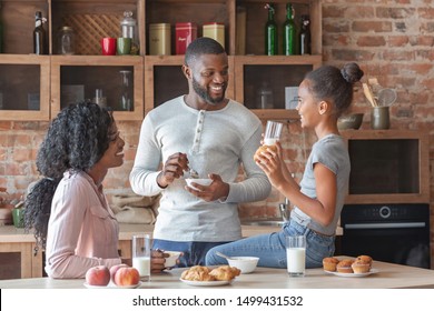 Friendly African American Family Of Three Talking At Kitchen During Breakfast, Free Space