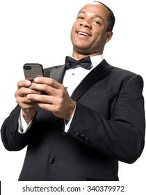 Friendly African man with short black hair in evening outfit using mobile phone - Isolated