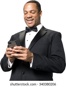 Friendly African man with short black hair in evening outfit using mobile phone - Isolated