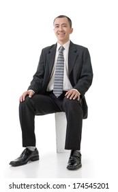 Friendly Asian Business Man Sit On Box, Full Length Portrait On White Background.