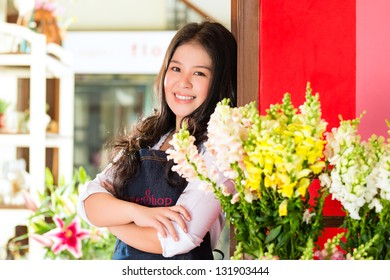 Friendly Asian Florist Or Saleswoman In A Flower Shop