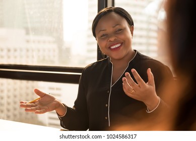 Friendly Black Businesswoman Leader Discussing Work With Colleague At The Meeting In Office