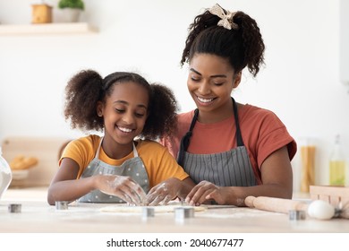 Friendly Black Family Mother And Daughter Making Diverse Figures With Cookie Cutters, Happy African American Mom And Kid Baking Together At Home, Using Biscuit Figurines, Baking Concept