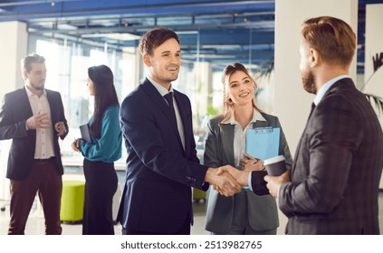 Friendly business people handshake deal, great, man leader boss shaking hand of new staff member welcome young male on job in corporate department, professional businesspeople agreement on negotiation - Powered by Shutterstock