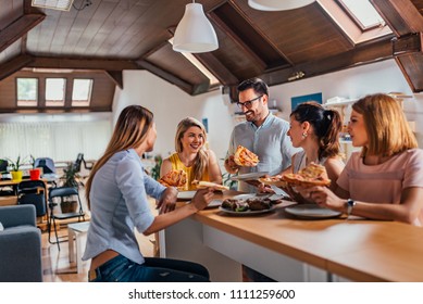 Friendly Business Team Colleagues Eating Pizza In Coworking Office.