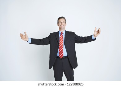 Friendly businessman standing with open arms