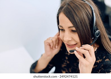 Friendly Call Center Agent Answering Incoming Calls with Headset Providing Remote Customer Service.