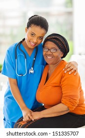 Friendly Caring Young African Nurse And Senior Patient 