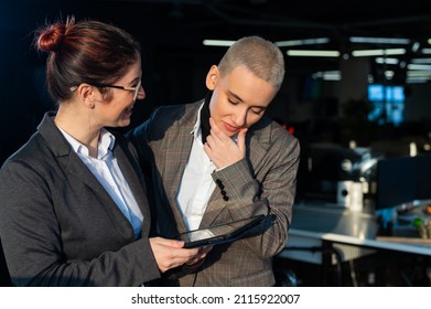 Friendly colleagues looking at a digital tablet. 