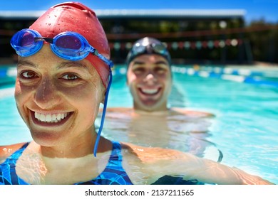 Friendly competition. Two swimmer standing in a pool smiling. - Powered by Shutterstock