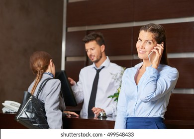 Friendly Concierge Serving Hotel Guests At Reception