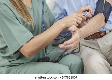 Friendly Confident Nurse Taking Blood Pressure Of Senior Male Patient