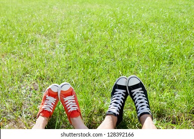 Friendly couple in sneackers in green grass - Powered by Shutterstock