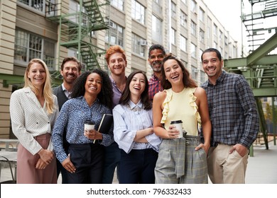 Friendly coworkers laugh to camera outside their workplace - Shutterstock ID 796332433
