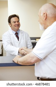 Friendly Doctor Greeting A New Patient At The Front Desk.