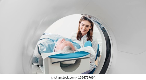 Friendly Doctor Talking To Patient . CT Scan In Hospital