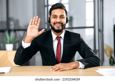 Friendly Elegant Indian Or Arabian Businessman, Financial Advisor, Sit At Desk In Modern Office, Having Video Call Conversation With Client, Male Economic Expert Records Online Training Course