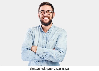 Friendly Face Portrait Of An Authentic Caucasian Bearded Man With Glasses Of Toothy Smiling Dressed Casual Against A White Wall Isolated