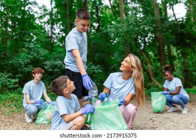 Friendly Family And Friends Organized A Cleaning Day To Clean The Park Of Household Garbage. People Participate In Natural Cleaning