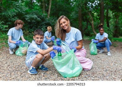 Friendly Family And Friends Organized A Cleaning Day To Clean The Park Of Household Garbage. People Participate In Natural Cleaning