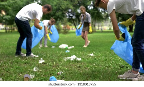 Friendly family organized cleaning day to clean park of household garbage - Powered by Shutterstock