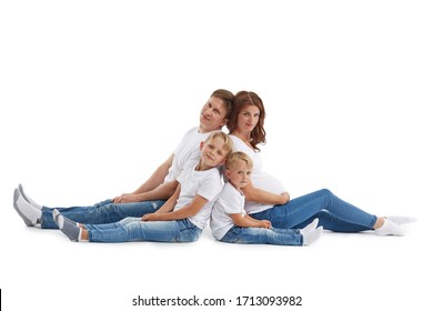 Friendly Family. Young Pregnant Woman And Her Husband Are Sitting With Backs To Each Other With Children, Isolated On A White Background.  Happy Parents. Pregnant Mother And Father With Two Sons